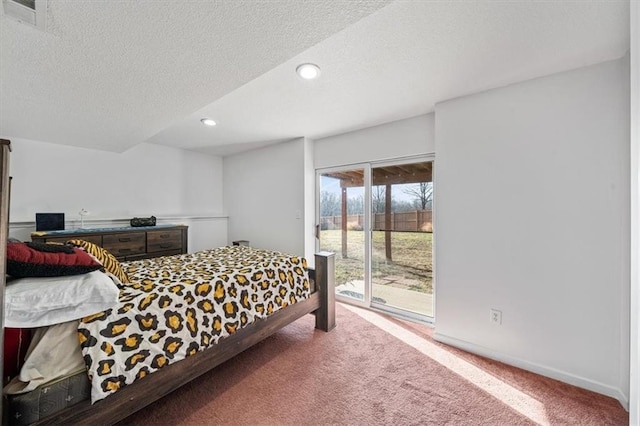 bedroom featuring a textured ceiling, carpet, and access to outside