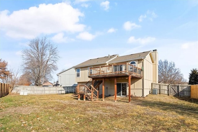 rear view of house with a wooden deck, a yard, and central AC