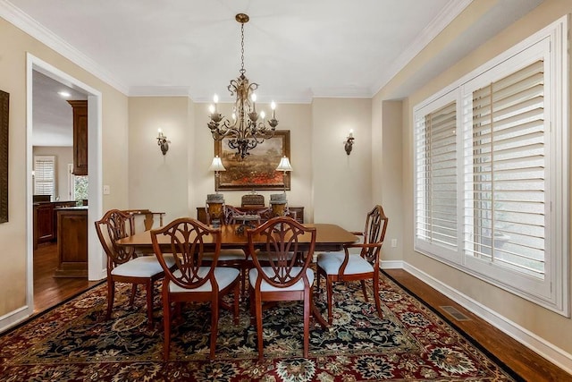 dining room with ornamental molding, dark hardwood / wood-style floors, and a healthy amount of sunlight