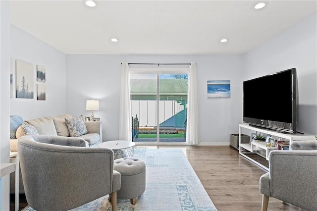 living area featuring recessed lighting, baseboards, and wood finished floors