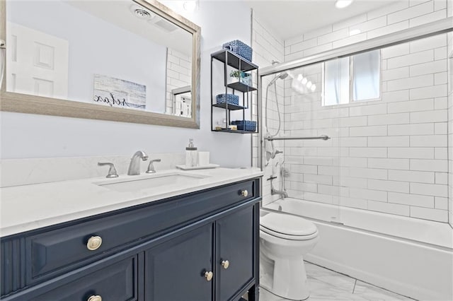 bathroom featuring marble finish floor, combined bath / shower with glass door, vanity, and toilet