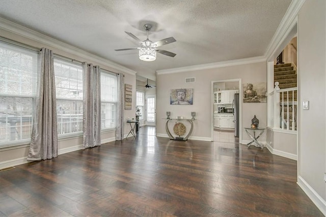 interior space with dark hardwood / wood-style flooring, ornamental molding, and a textured ceiling