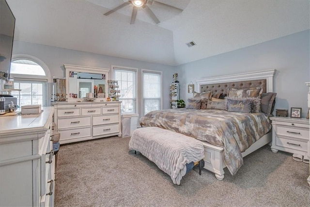 carpeted bedroom with vaulted ceiling and ceiling fan