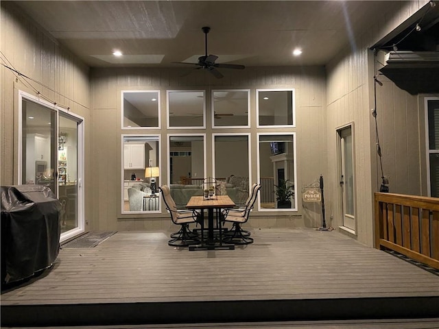 wooden deck with ceiling fan and area for grilling