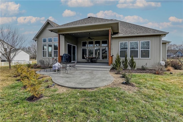 back of house with a patio, ceiling fan, and a lawn