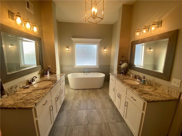 bathroom featuring vanity, tile walls, and a tub