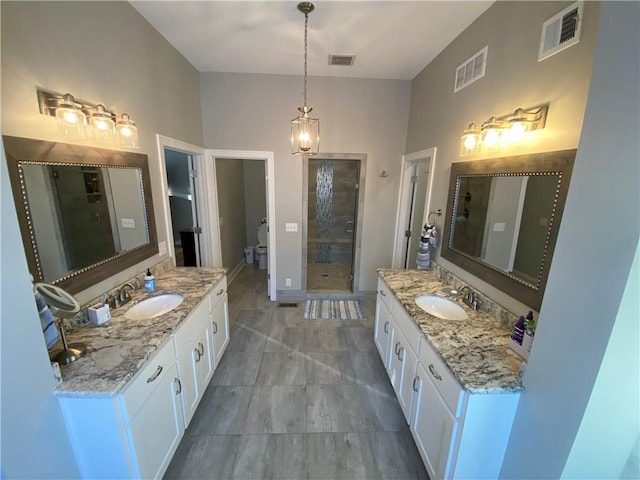 bathroom featuring walk in shower, vanity, and toilet