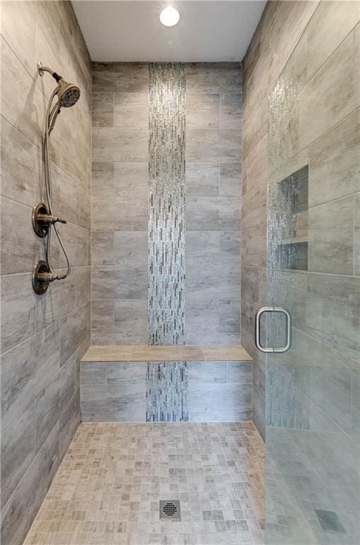 bathroom with a shower with shower door