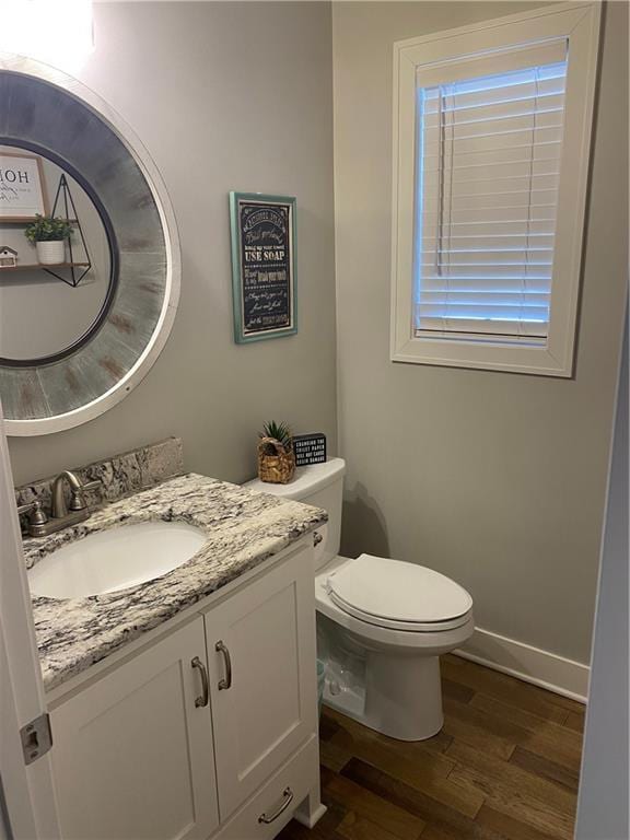 bathroom with vanity, hardwood / wood-style floors, and toilet