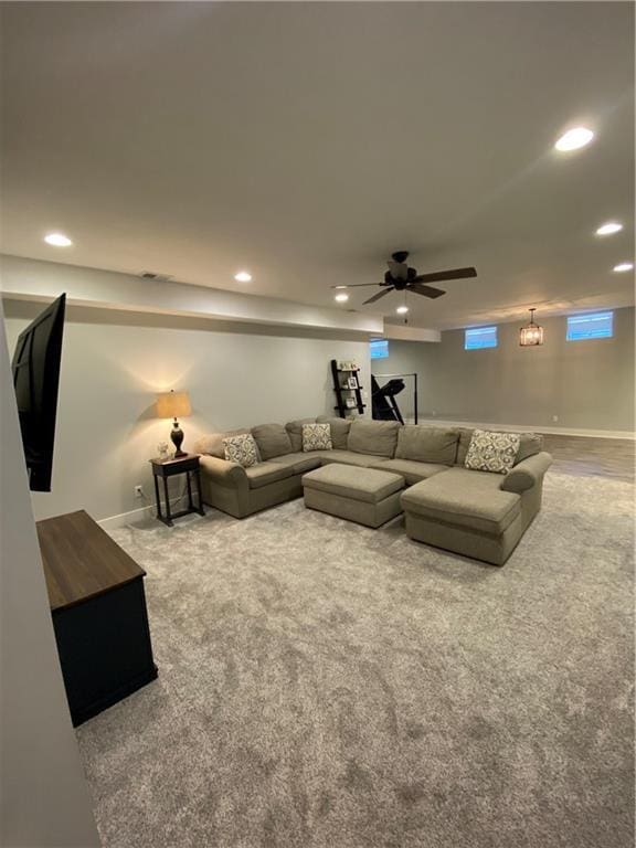 living room with ceiling fan and carpet flooring