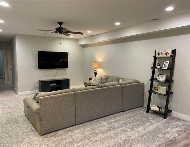 carpeted living room with ceiling fan