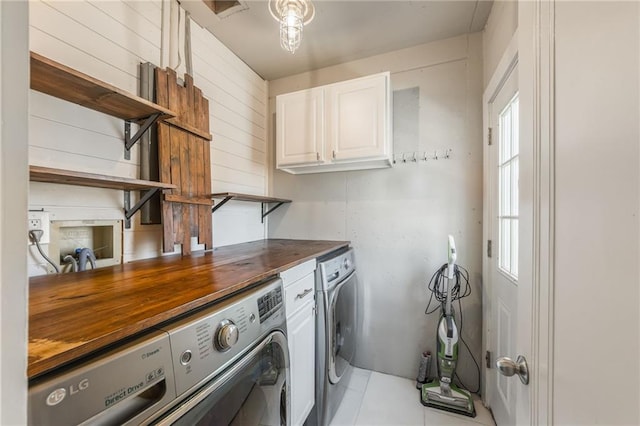 laundry room with washing machine and dryer and cabinet space