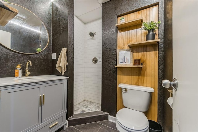 bathroom featuring a stall shower, vanity, toilet, and tile patterned floors