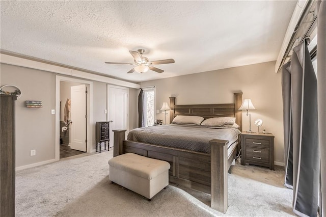 bedroom featuring light carpet, a textured ceiling, a ceiling fan, and baseboards