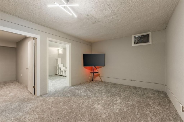 interior space with carpet and a textured ceiling