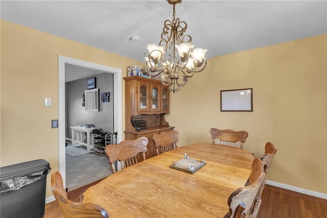 dining space featuring an inviting chandelier and hardwood / wood-style floors