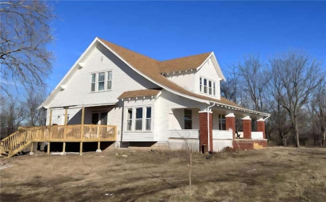 rear view of house with a wooden deck