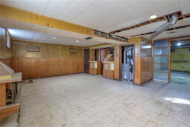 basement featuring wood walls