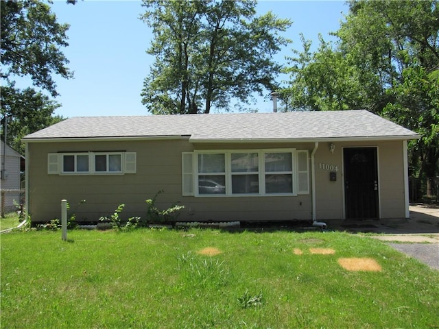 ranch-style home with a front lawn