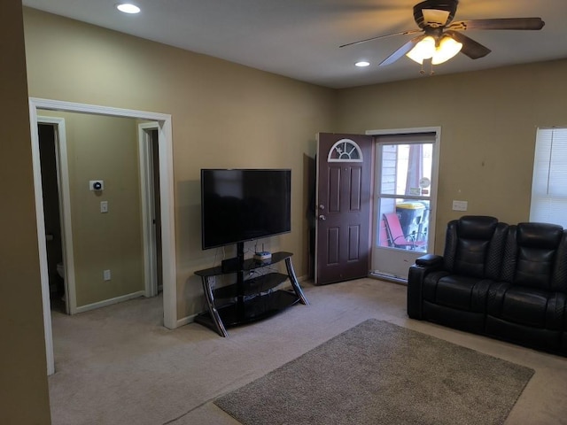 carpeted living room featuring ceiling fan