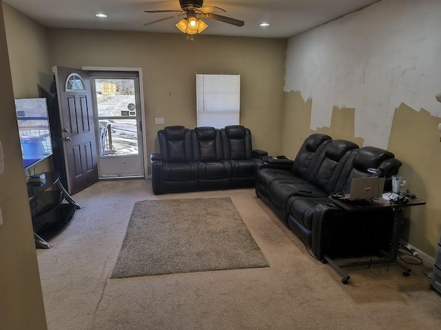 carpeted living room with ceiling fan