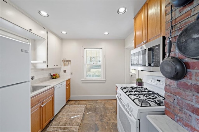 kitchen featuring white appliances, baseboards, light countertops, tasteful backsplash, and brown cabinetry