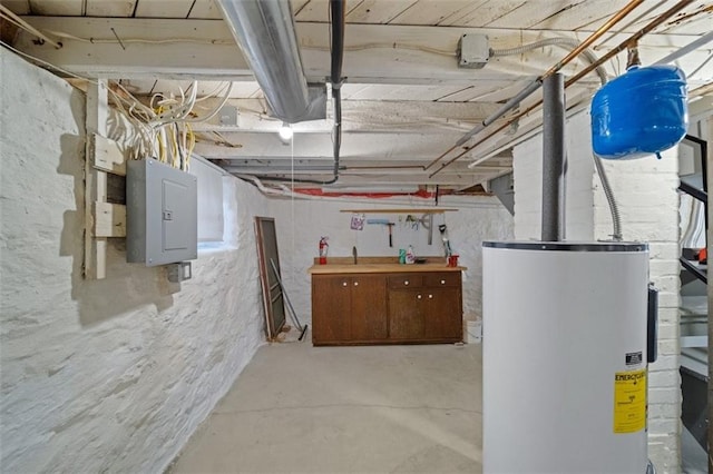 utility room featuring electric panel and water heater