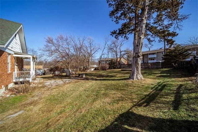 view of yard featuring a residential view and fence