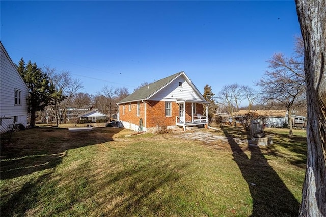 view of home's exterior with a yard and brick siding