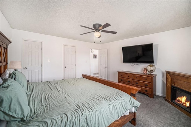 carpeted bedroom with a textured ceiling and ceiling fan