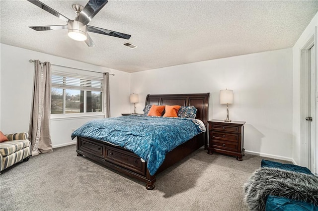 carpeted bedroom featuring a textured ceiling and ceiling fan