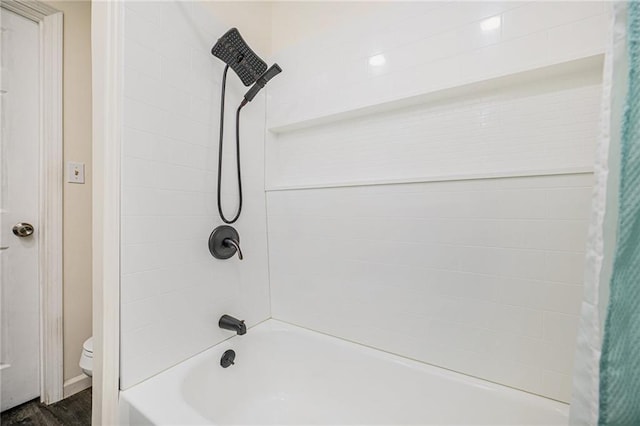 bathroom featuring toilet, shower / bathtub combination with curtain, and hardwood / wood-style flooring