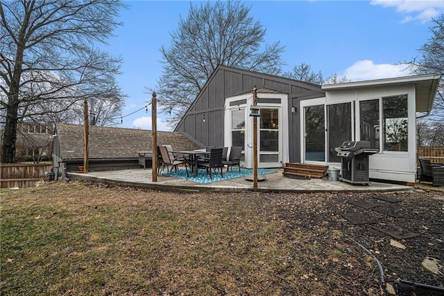 rear view of house with a patio and a yard