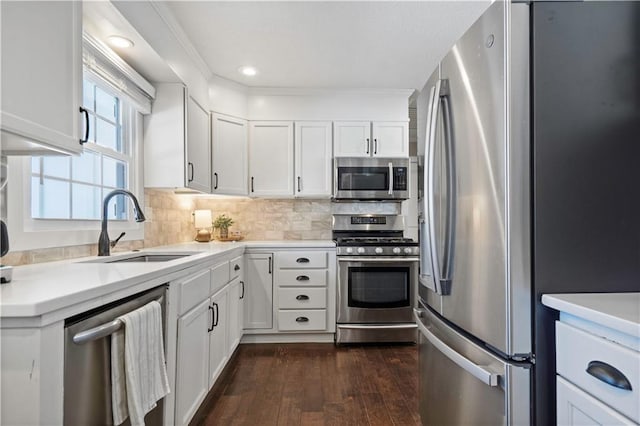 kitchen featuring dark wood-style flooring, white cabinetry, stainless steel appliances, and a sink