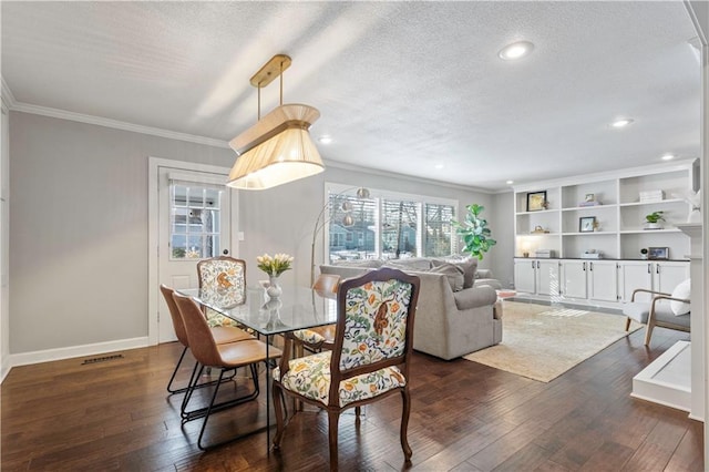 dining room featuring dark wood-type flooring, baseboards, visible vents, and a textured ceiling