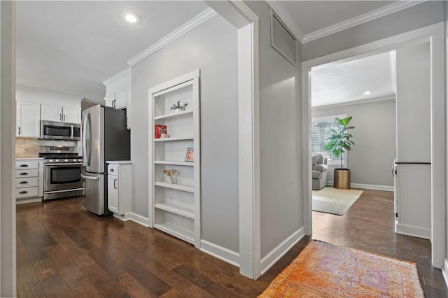 corridor with baseboards, built in features, ornamental molding, recessed lighting, and dark wood-style floors