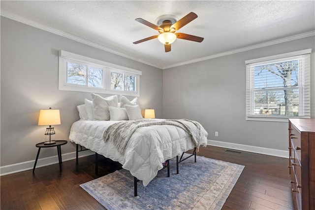 bedroom featuring dark wood-style floors, a textured ceiling, baseboards, and ornamental molding