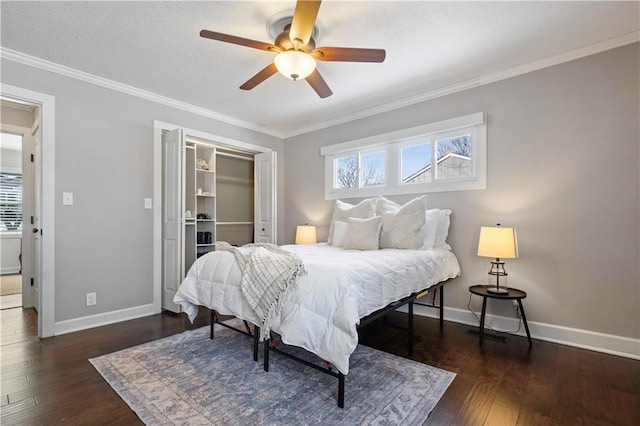 bedroom featuring a closet, multiple windows, ornamental molding, and hardwood / wood-style flooring