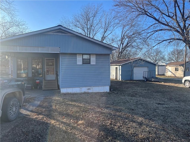 back of property featuring an outbuilding and a garage