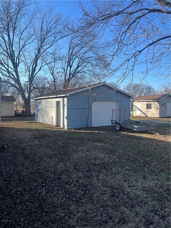 garage featuring a lawn