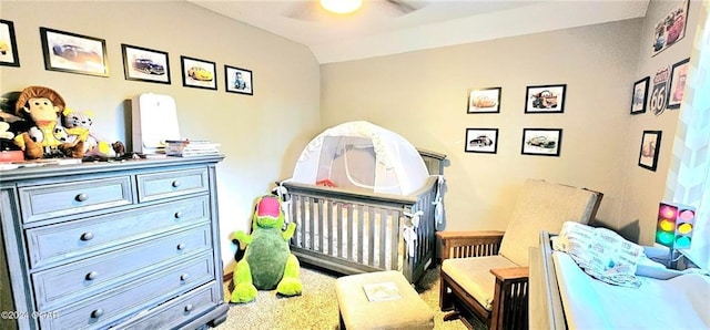 carpeted bedroom with vaulted ceiling and ceiling fan