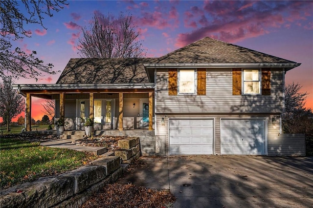 view of front of home with a porch and a garage