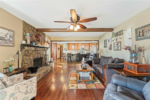 living room with beam ceiling, a fireplace, dark hardwood / wood-style floors, and ceiling fan