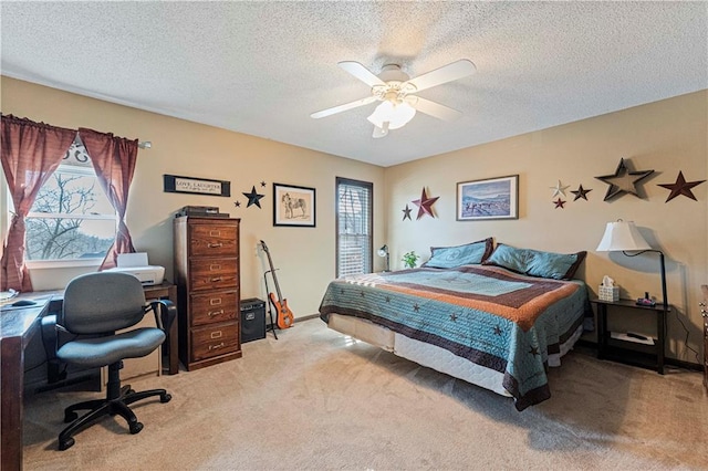 bedroom featuring carpet, a textured ceiling, and ceiling fan