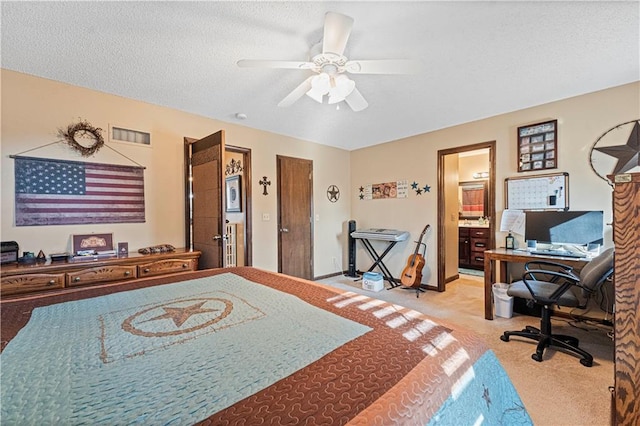 carpeted bedroom with ceiling fan, connected bathroom, and a textured ceiling