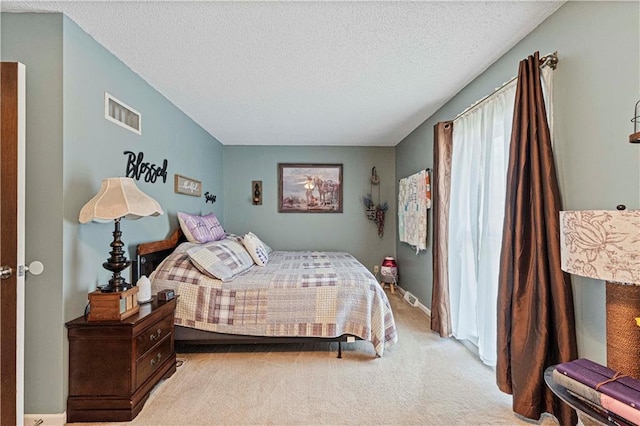 carpeted bedroom featuring a textured ceiling