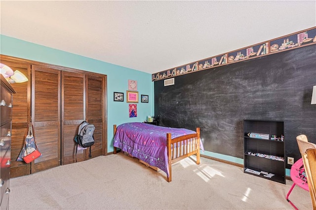 carpeted bedroom featuring a closet