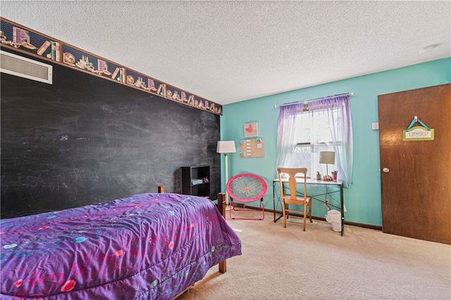 carpeted bedroom featuring a textured ceiling