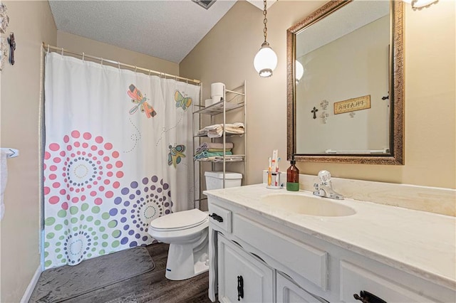 bathroom with hardwood / wood-style flooring, vanity, a textured ceiling, a shower with curtain, and toilet