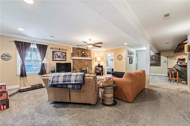 carpeted living room with crown molding, a fireplace, and ceiling fan